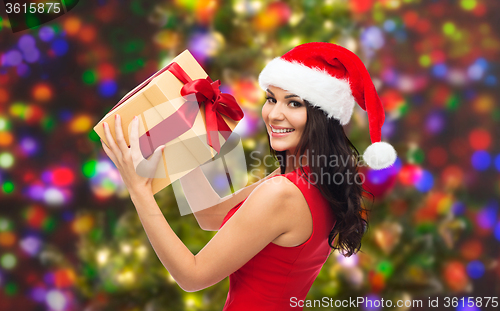 Image of beautiful sexy woman in santa hat with gift box