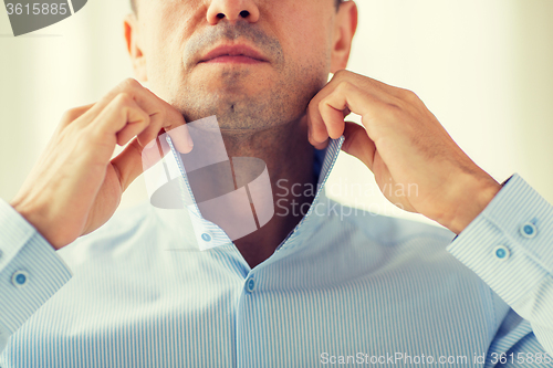 Image of close up of man in shirt dressing 