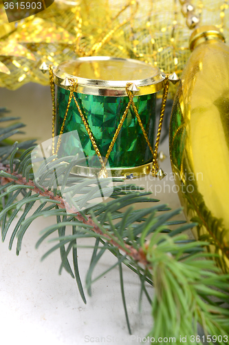 Image of Christmas background with drums, green eve tree branch, golden new year decoration 