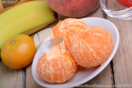 Image of Fresh colorful fruits composition mandarin, strawberry, peach, bananas and orange