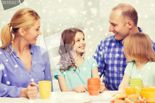 Image of happy family with two kids having breakfast