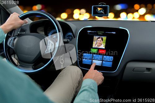 Image of close up of man driving car and receiving call