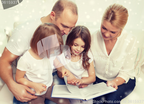 Image of happy family with book at home