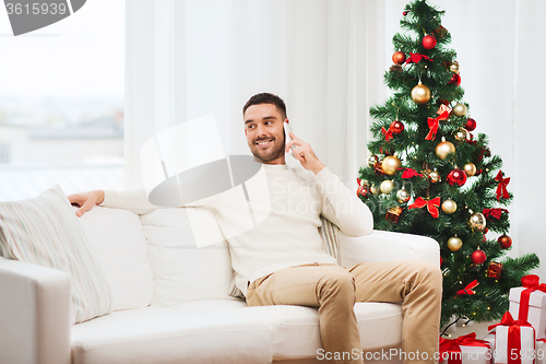 Image of man calling on smartphone at home for christmas
