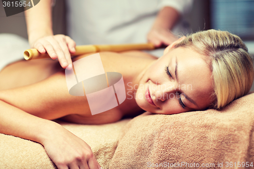 Image of close up of woman lying and having massage in spa