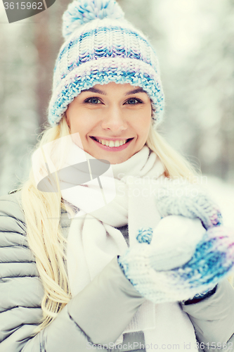 Image of smiling young woman in winter forest