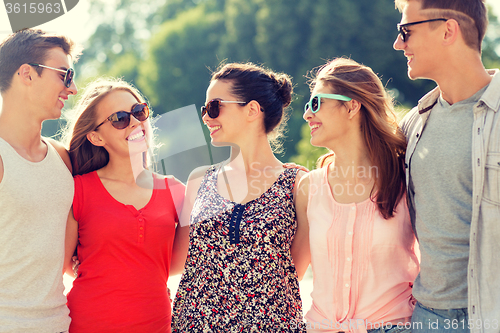 Image of group of smiling friends in city