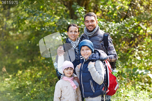 Image of happy family with backpacks hiking