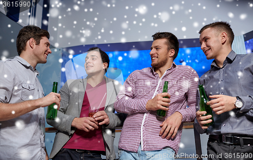 Image of group of male friends with beer in nightclub