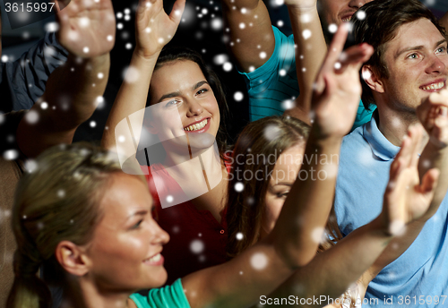 Image of smiling friends at concert in club