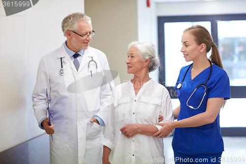 Image of medics and senior patient woman at hospital