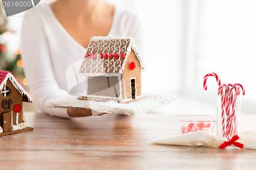 Image of close up of woman showing gingerbread house