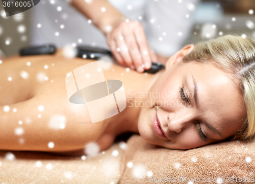 Image of close up of woman having hot stone massage in spa