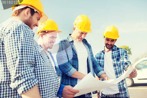 Image of group of builders with tablet pc and blueprint