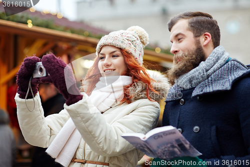 Image of couple taking selfie with smartphone in old town