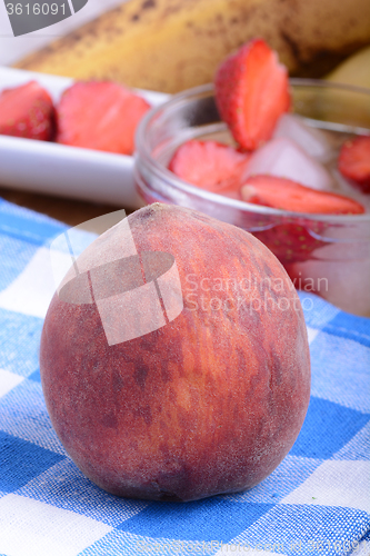 Image of peach strawberry bananas mandarin close up as health food concept