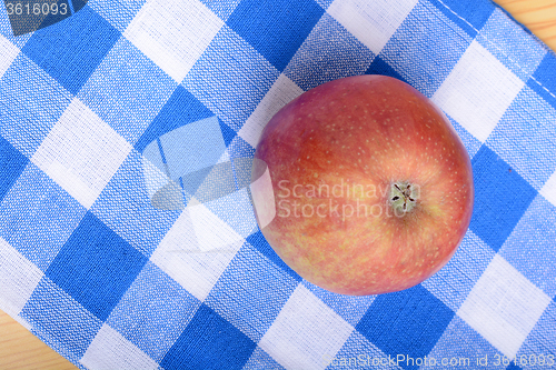 Image of Red apple top view on blue material background