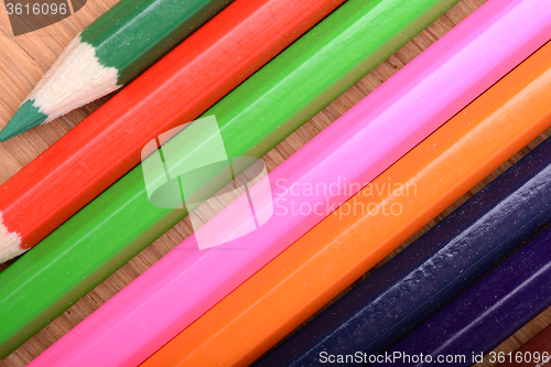 Image of Frame of old Colour pencils on Old wooden plate texture background
