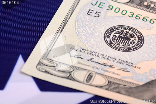 Image of american dollars bills on flag background