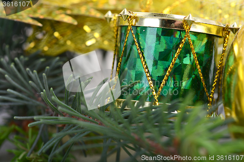 Image of Christmas background with drums, green eve tree branch, golden new year decoration 