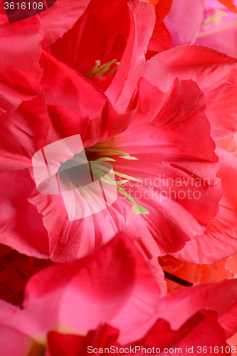 Image of artificial flowers red handmade velor tissue background close up