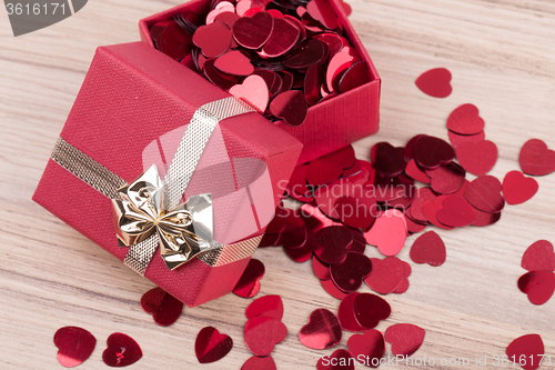 Image of Red hearts confetti on wooden background