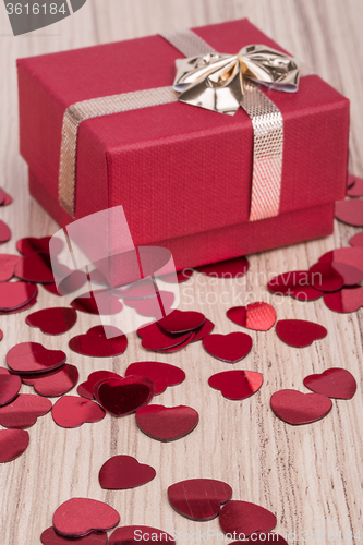 Image of Red hearts confetti on wooden background