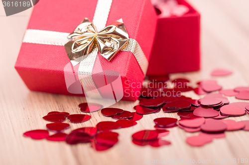 Image of Red hearts confetti on wooden background