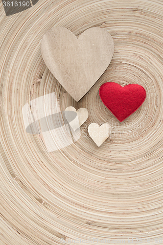 Image of valentine\'s wooden hearts on a retro background