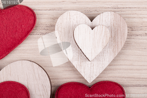 Image of valentine\'s wooden hearts on a retro background