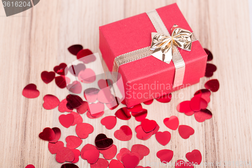 Image of Red hearts confetti on wooden background