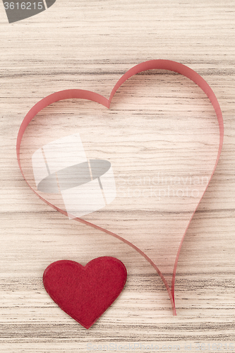 Image of valentine\'s paper hearts on a wooden background