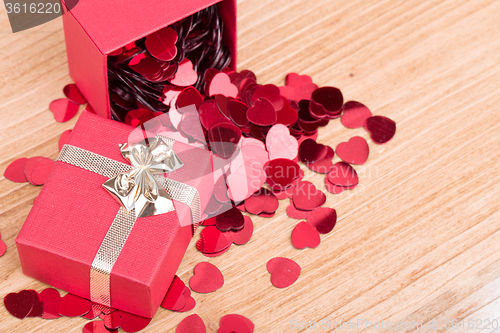 Image of Red hearts confetti on wooden background