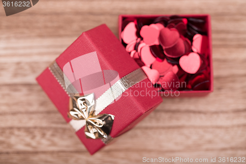 Image of Red hearts confetti on wooden background