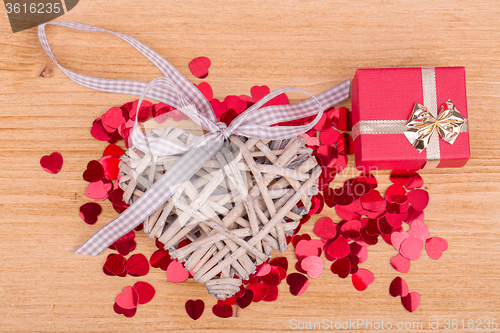 Image of Red hearts confetti on wooden background