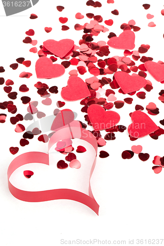 Image of Red hearts confetti and fabric heart on white background