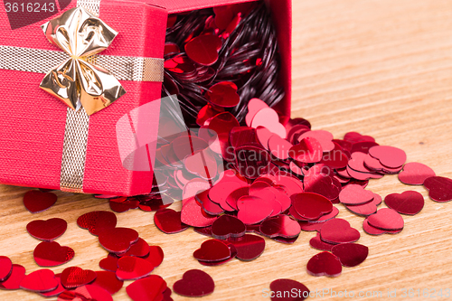 Image of Red hearts confetti on wooden background