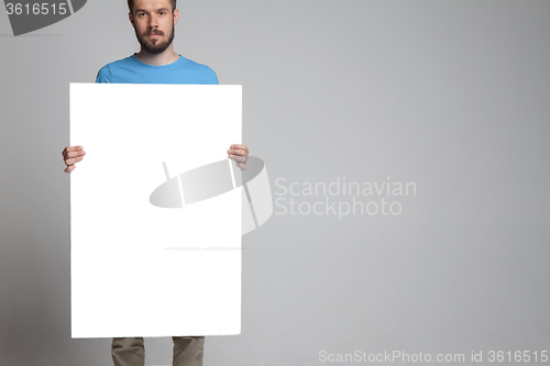 Image of The man showing empty white billboard or banner 