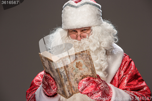 Image of Santa Claus reading book