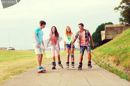 Image of group of smiling teenagers with roller-skates