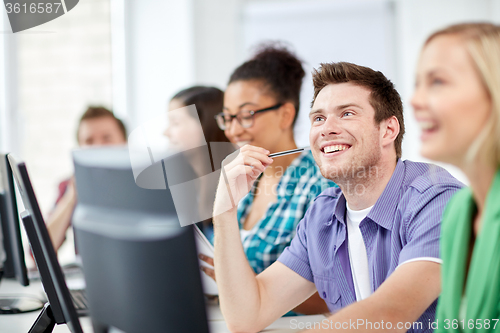 Image of happy high school students in computer class