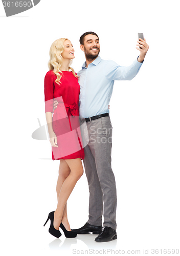 Image of happy couple taking selfie with smartphone