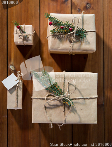 Image of close up of christmas gifts with fir brunch