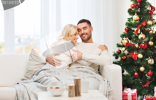 Image of happy couple at home with christmas tree