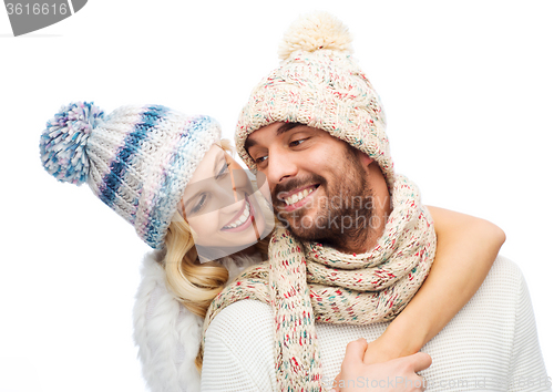 Image of smiling couple in winter clothes hugging