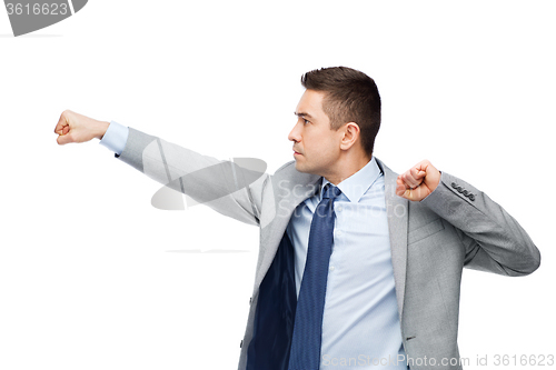 Image of businessman in suit fighting with someone