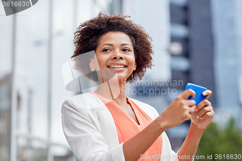 Image of happy african businesswoman with smartphone