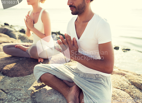 Image of close up of couple making yoga exercises outdoors