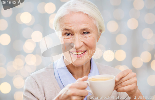 Image of happy senior woman with cup of coffee