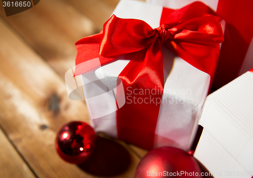 Image of close up of gift boxes and red christmas balls